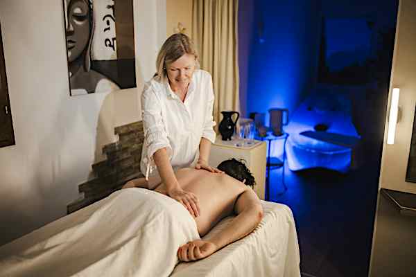 Time Out Spa Woman massages client in spa